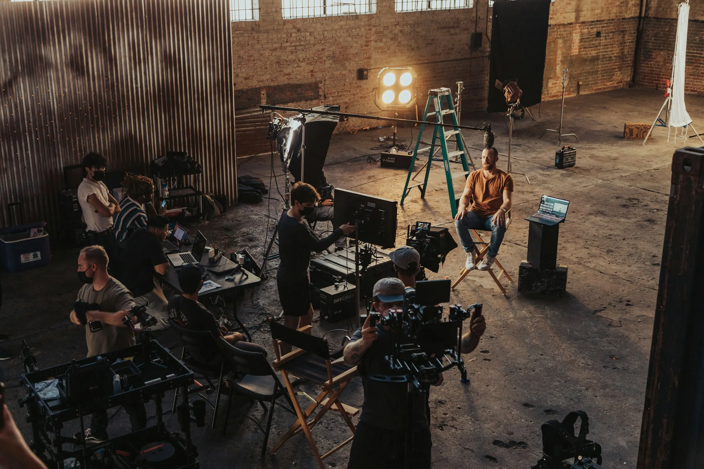 A production crew working around camera equipment on a film set