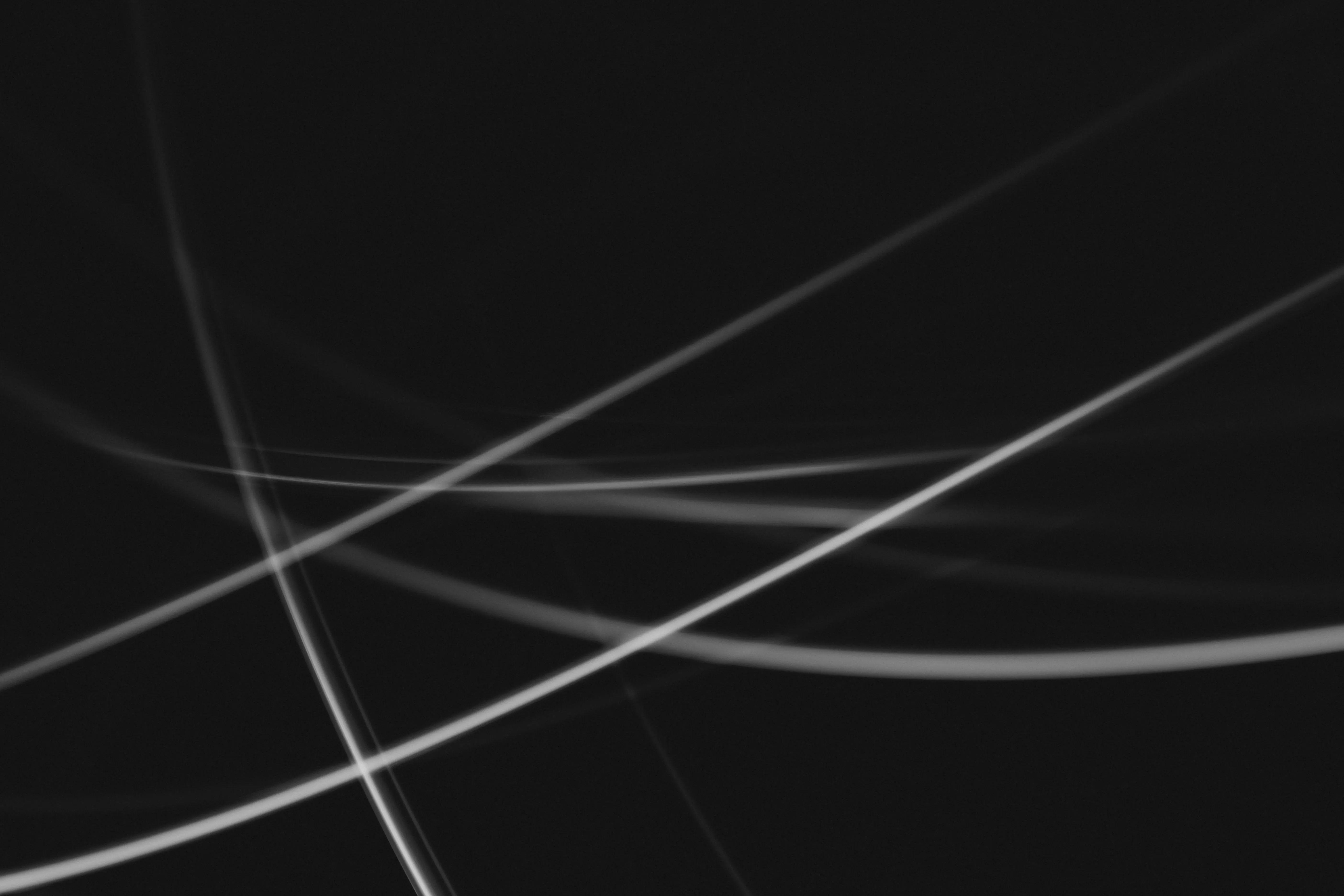 White light streaks curving across black
