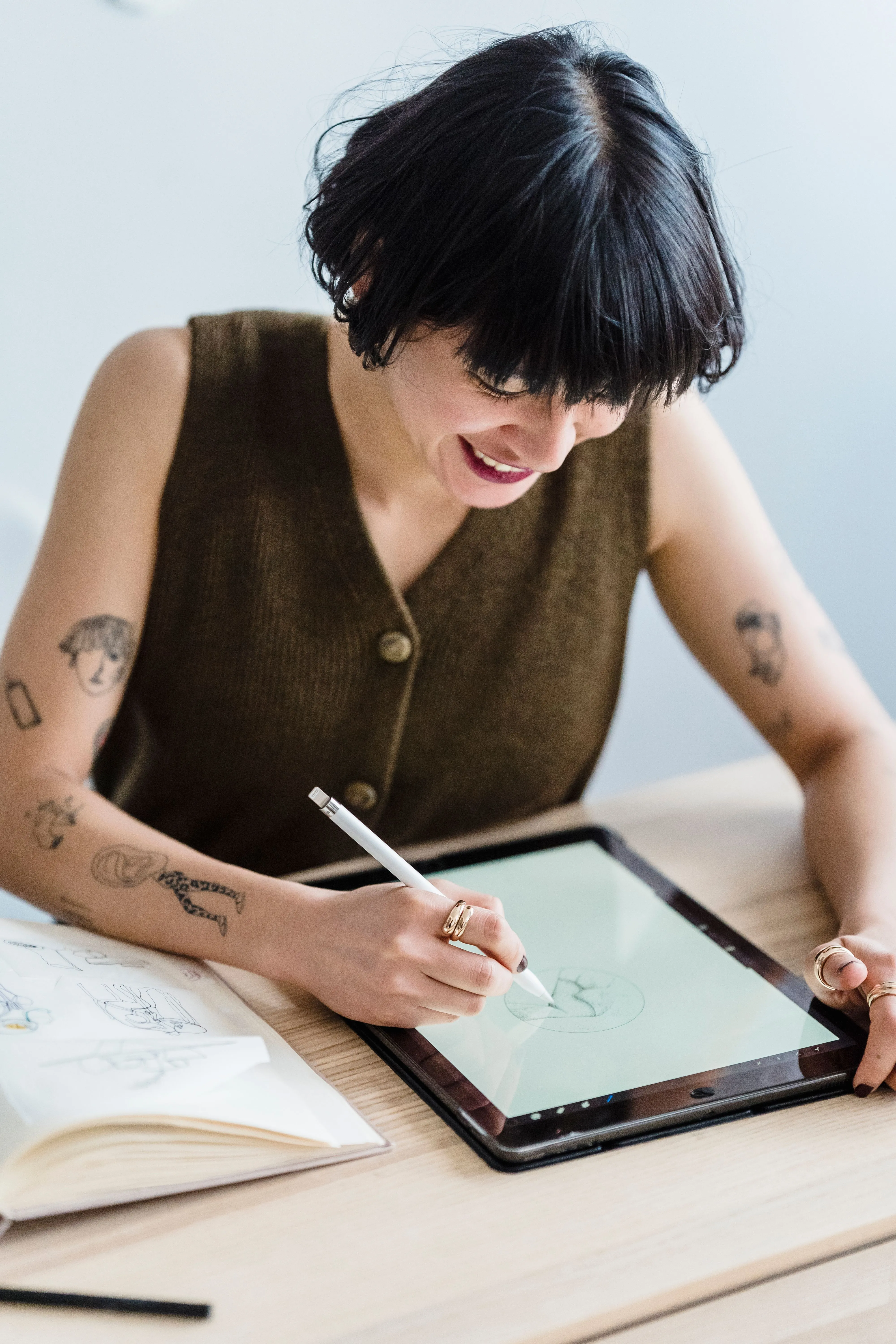 An artist sketching on a tablet with a stylus